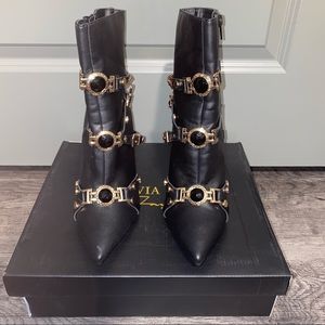 Black booties with gold accents